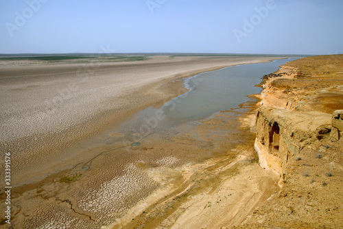 Amu Darya River flows through the Kyzylkum desert. Outskirts of Khiva town, Uzbekistan. photo