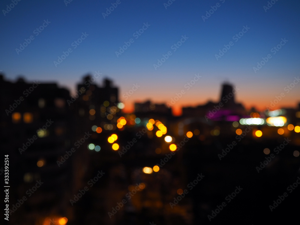 blurry lights of the evening city at sunset