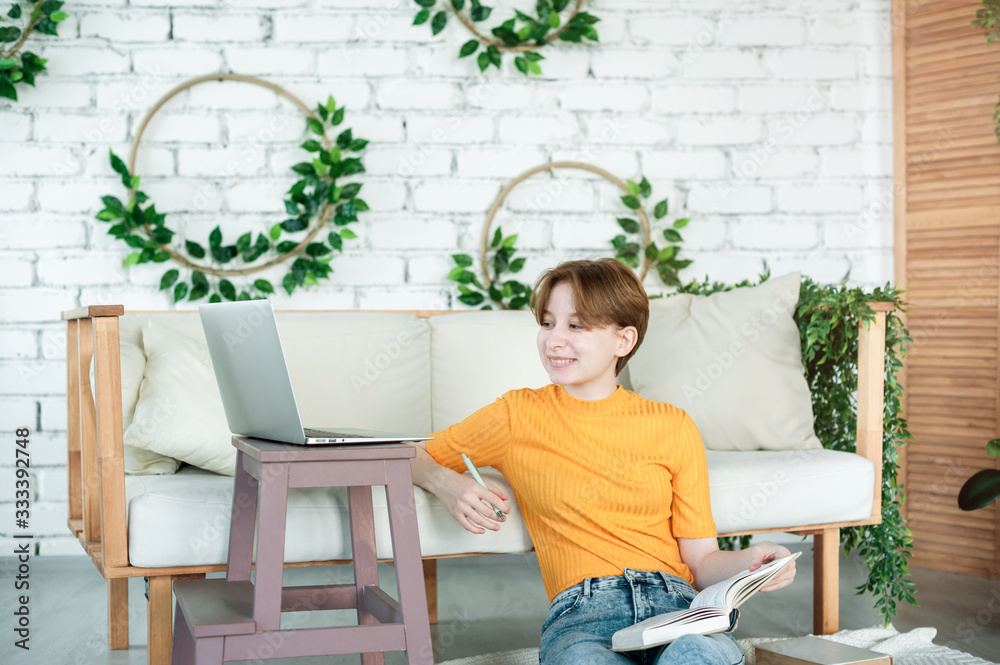 Girl sitting on floor next to laptop on stand Girl sitting on floor next to laptop on stand