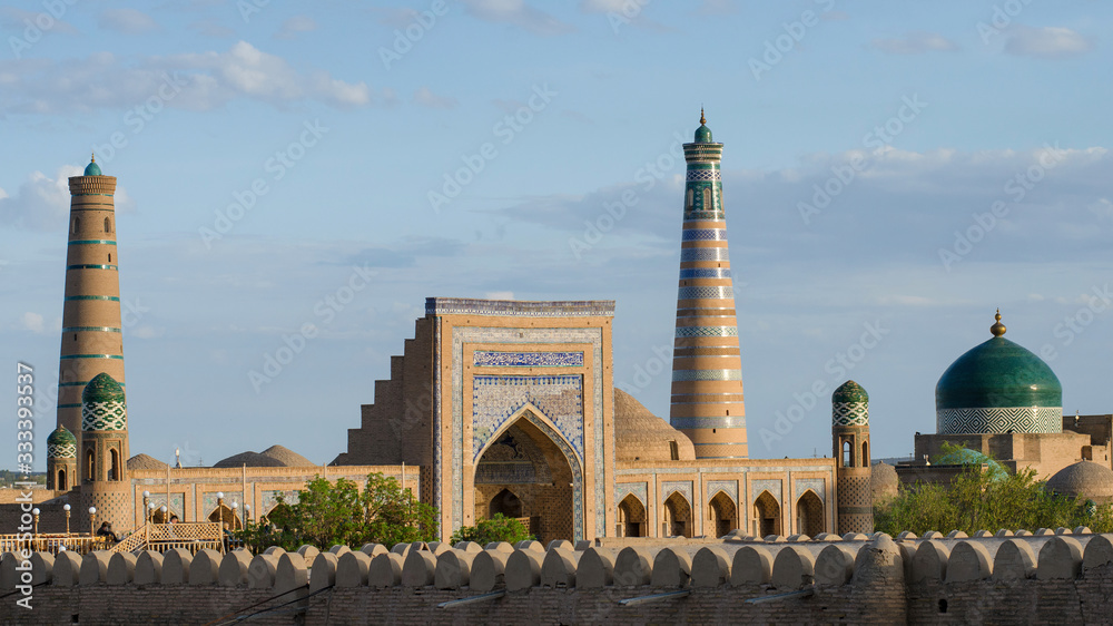 View at Itchan Kala (old or inner town), Juma mosque minaret, Mohammed Rakhim Khan Madrasah, Islam Khoja Minaret and Pakhlavan Makhmud Mausoleum. Khiva, Uzbekistan, Central Asia.