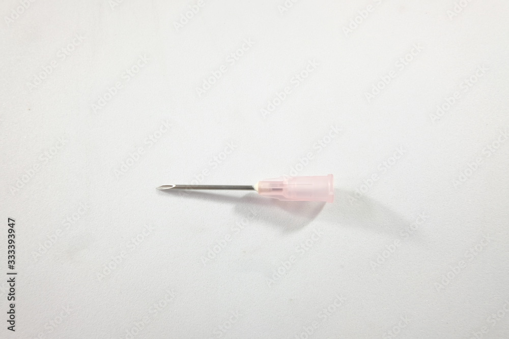 pink hypodermic needle or injection needle on a white blackground pink hypodermic needle or injection needle on a white blackground