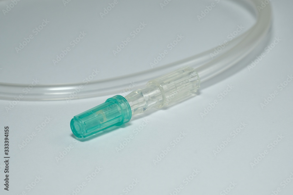 Extension Tube for Medical The end of the cable has a green lid on a White blurred background Extension Tube for Medical The end of the cable has a green lid on a White blurred background
