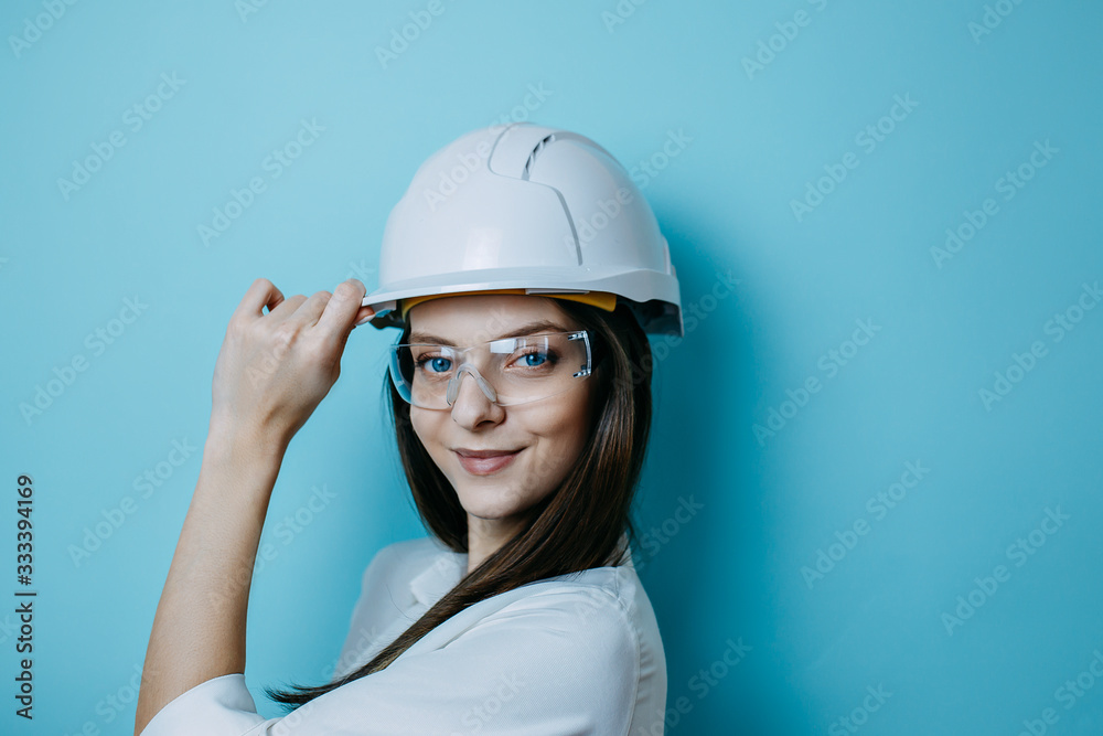 Woman engineer in white helmet and glasses, protective clothes., helmet and protective glasses. Woman engineer in white helmet and glasses, protective clothes., helmet and protective glasses.