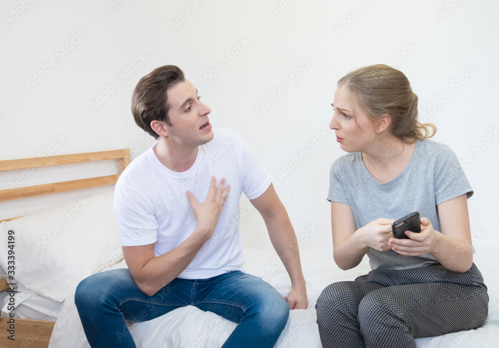 caucasian unhappy man and woman have argument on smart mobile phone in home, relationship social problem concept with copy space. caucasian unhappy man and woman have argument on smart mobile phone in home, relationship social problem concept with copy space.