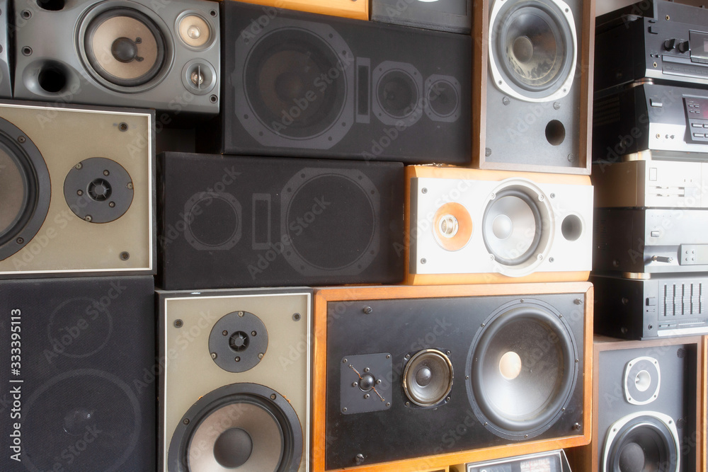 Obraz premium Music sound speakers hanging on the wall in retro vintage style, stacked sound boxes modern