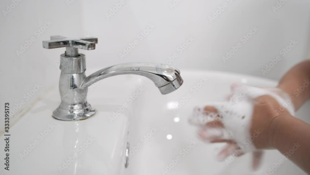 Asian boy about 4 year old washing hands with soap using 7 steps technique Asian boy about 4 year old washing hands with soap using 7 steps technique