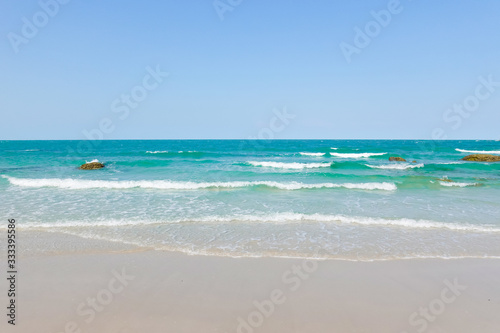 Ocean waves on the sandy beach for background, concept of the beach in the summer