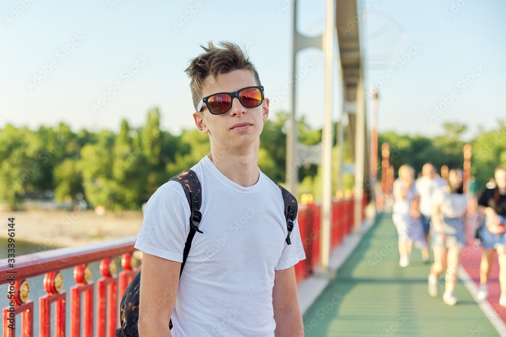 Teen boy 15 years old with fashionable hairstyle sunglasses looking at  camera Stock Photo