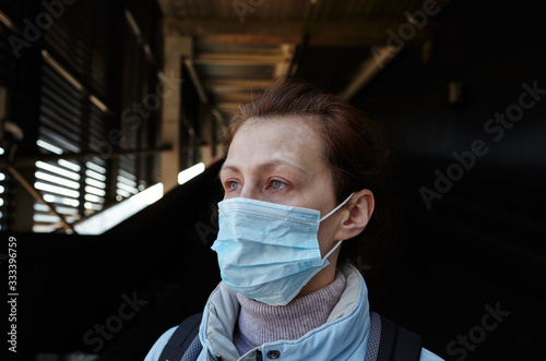 Woman wearing hygienic mask to prevent the Coronavirus.People in masks The outbreak of Novel Corona virus (2019-nCoV) in Europe.Concept of coronavirus quarantine.Girl in a medical mask in quarantine