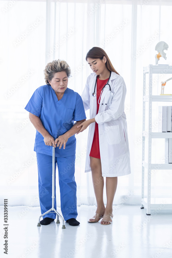 Young attractive Asian doctor is helping an old patient walking, hospital and healthcare concept. Young attractive Asian doctor is helping an old patient walking, hospital and healthcare concept.