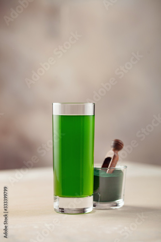 Glass of spirulina drink powder on table. Food and drink, dieting and nutrition concept.