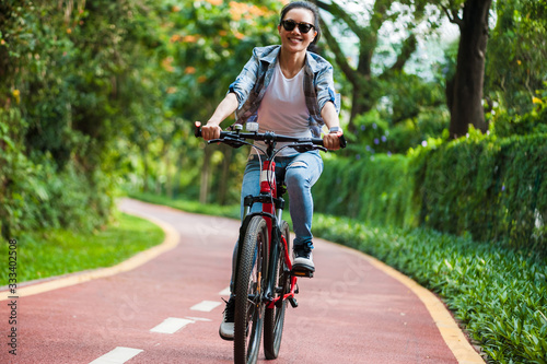 Woman cyclist riding mountain bike in park