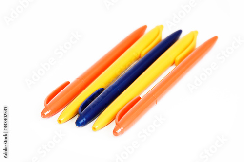 multicolored plastic stationery pens on a white background