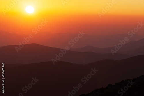 Sunset on the mountain with the layers of the hills