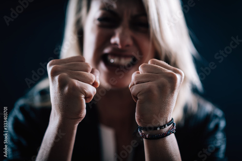 Aggression – Portrait of an Angry Aggressive Woman with Clenched Fists