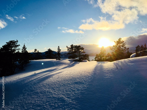 Sunset on a snowy Mountain with conifers and clouds in Norway - Landscape Photography © Flipz