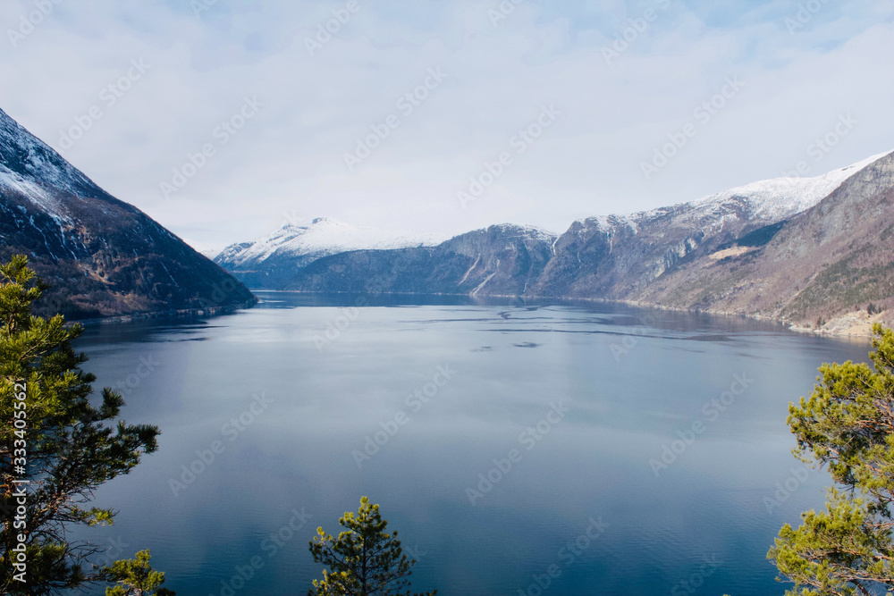 Beautiful view from a mountain to the Eidfjord with snowy moutains in the background in Norway - Landscape Photography Beautiful view from a mountain to the Eidfjord with snowy moutains in the background in Norway - Landscape Photography