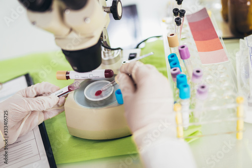 Doctor in the laboratory with a biological tube for analysis and sampling of Covid-19 infectious disea. photo