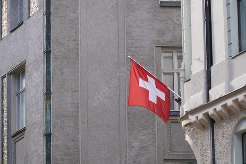 Swiss Flag hanging from Building Facade photo