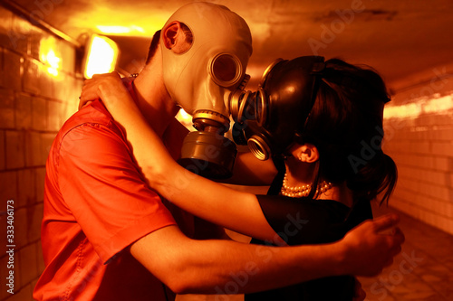 Married couple in gas masks in a tunnel