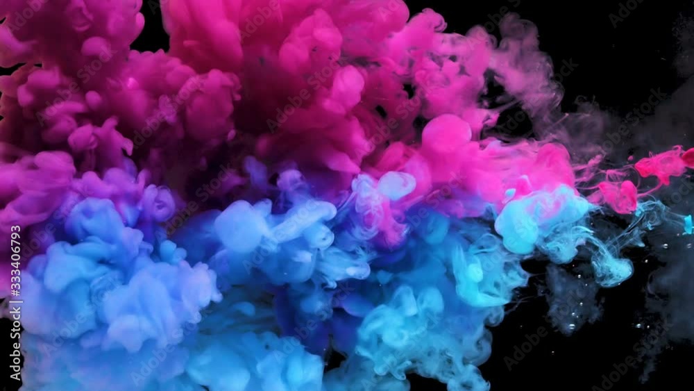Colors ink splashing in water isolated on black background.