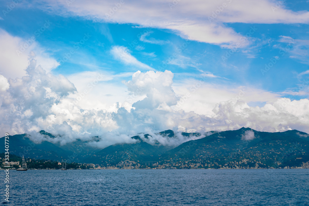 Wide panoramic view of Italian Riviera from the sea on cloudy day