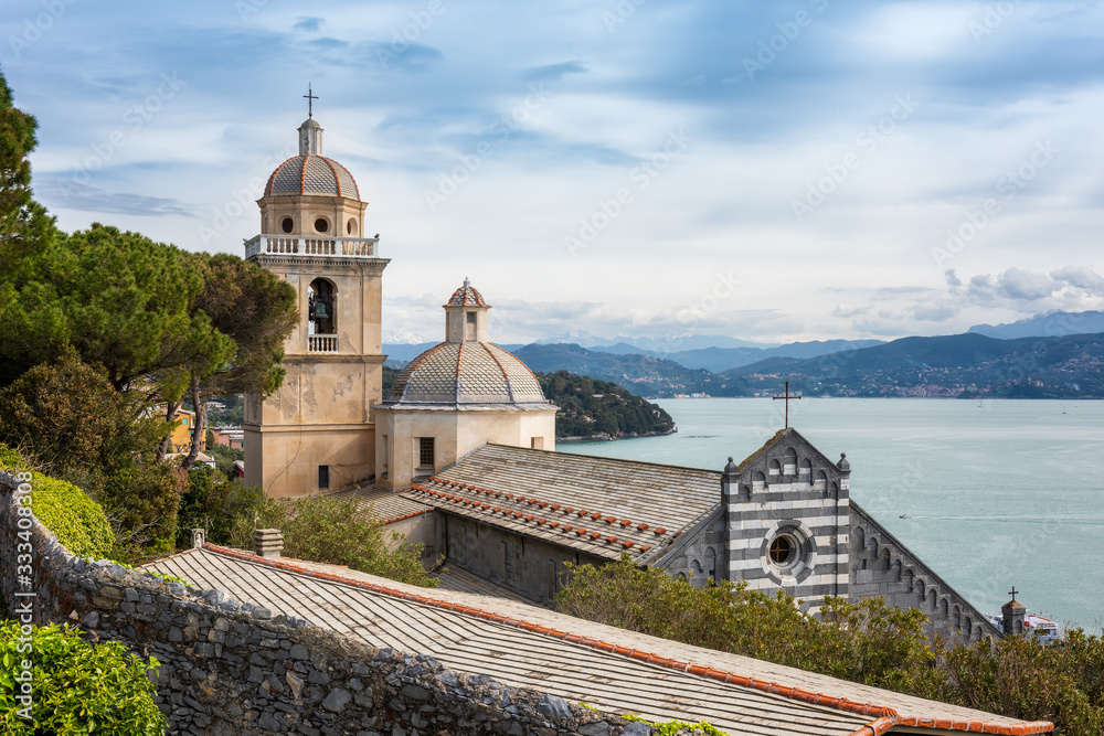 A view from the grounds of Doria Castle towards the Church of San Lorenzo(Chiesa di San Lorenzo) with view on the Bay of Poets in Porto Venere, Italy A view from the grounds of Doria Castle towards the Church of San Lorenzo(Chiesa di San Lorenzo) with view on the Bay of Poets in Porto Venere, Italy