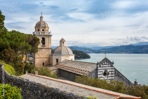 A view from the grounds of Doria Castle towards the Church of San Lorenzo Chiesa di San Lorenzo  with view on the Bay of Poets in Porto Venere  Italy
