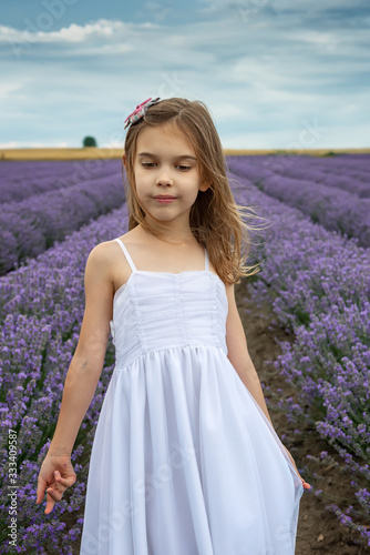 Portrait of a little girl in a fully bloomed lavender field