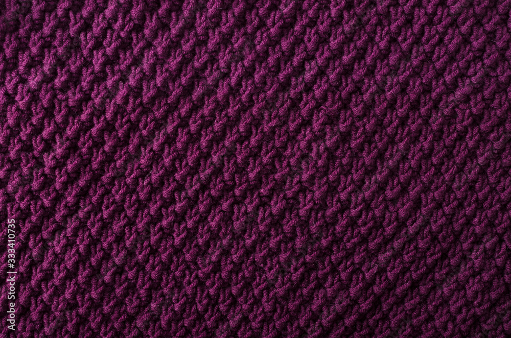 Texture of dark purple knitted fabric as a background.Empty space for design Texture of dark purple knitted fabric as a background.Empty space for design
