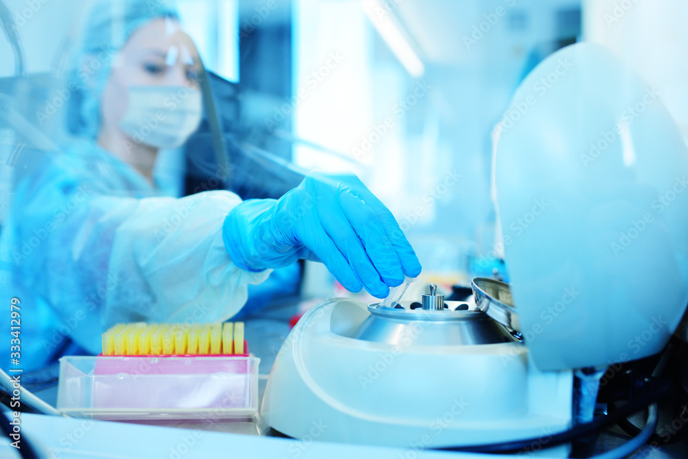 a female scientist in a protective medical mask and rubber gloves makes PCR DNA tests in a modern chemical and bacteriological laboratory.2019-nCoV; coronavirus; China; a female scientist in a protective medical mask and rubber gloves makes PCR DNA tests in a modern chemical and bacteriological laboratory.2019-nCoV; coronavirus; China;