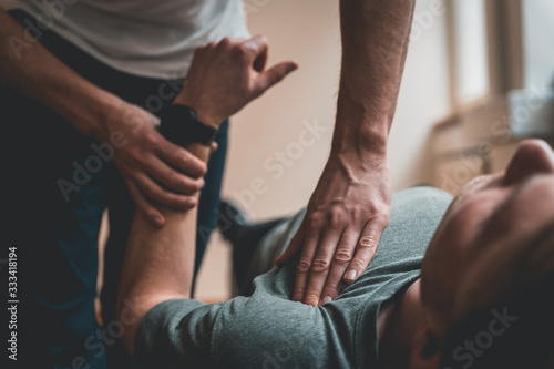 Physiotherapist treating patient for various physical ailments photo