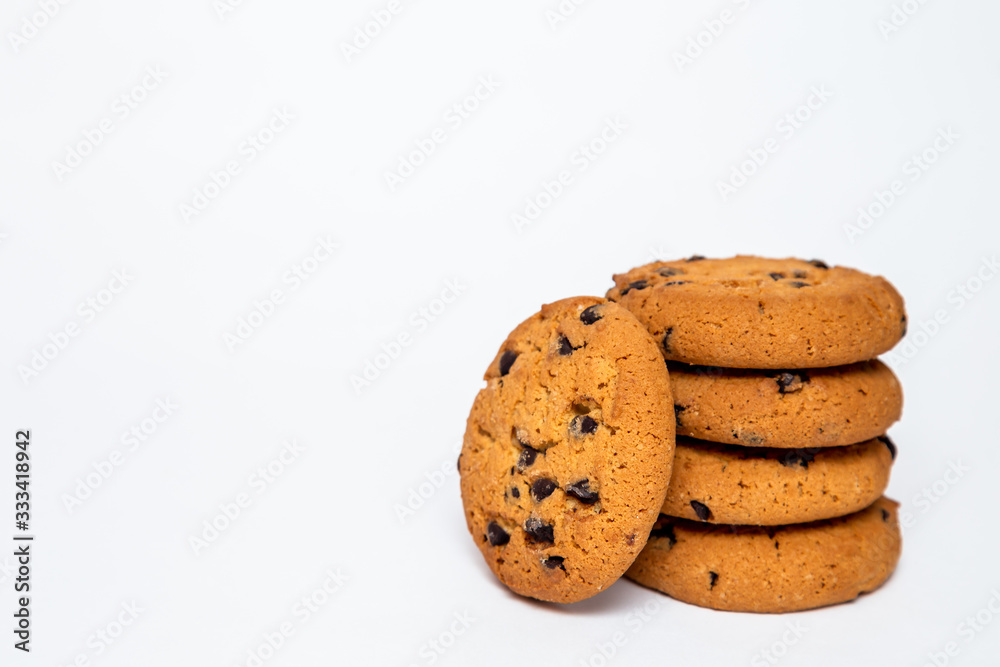 homemade cookies with pieces of chocolate for breakfast lie on a white isolated background.