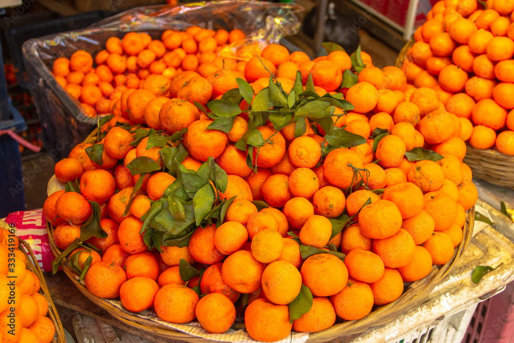 Fresh picked mandarins. Fresh mandarin oranges fruit or tangerines. Mandarins sell on a food market.