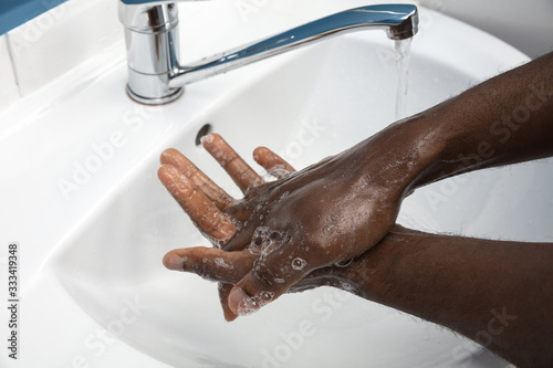 Принти на полотні Man washing hands carefully with soap and sanitizer, close up
