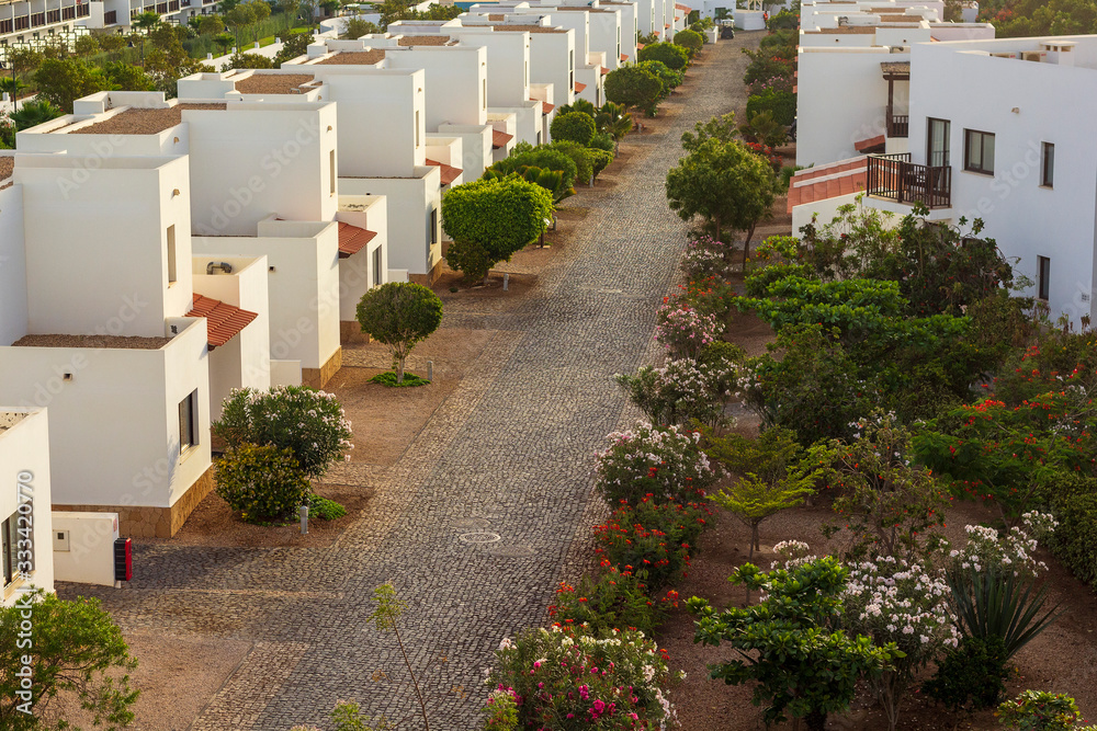 Street through a row of holiday apartments and villas near Santa Maria in Cape Verde on the island of Sal