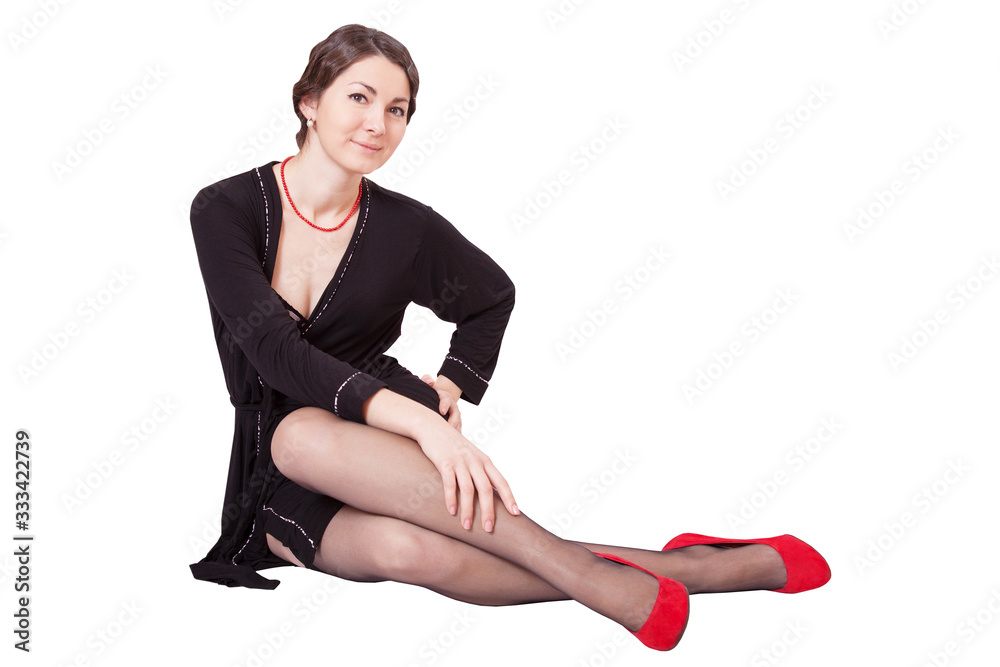 Portrait of a beautiful young woman in a black dressing gown and red shoes Portrait of a beautiful young woman in a black dressing gown and red shoes