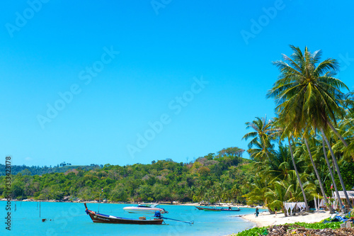 Tropical beach landscape. Perfect white sand, green palm trees and blue water. Travel and relaxation in the tropics © Kate
