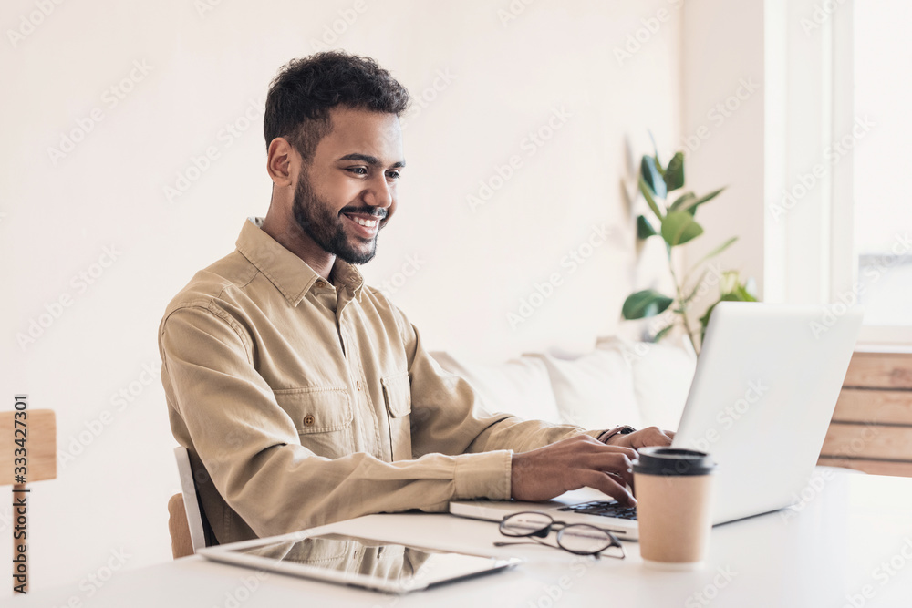 © kite_rin - Young handsome man using laptop at home, Businessman or student working online on computer indoors, Freelance, online marketing, distance education, home work and technology concept © kite_rin - Young handsome man using laptop at home, Businessman or student working online on computer indoors, Freelance, online marketing, distance education, home work and technology concept