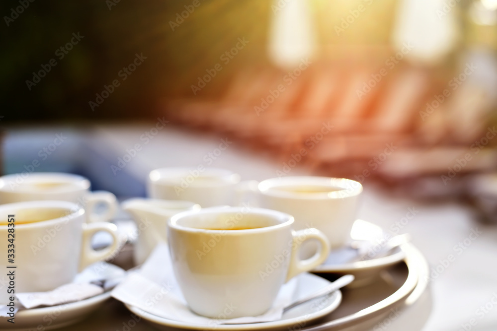 Blurred abstract image out of focus cups of coffee on a table on the street. Blurred abstract image out of focus cups of coffee on a table on the street.