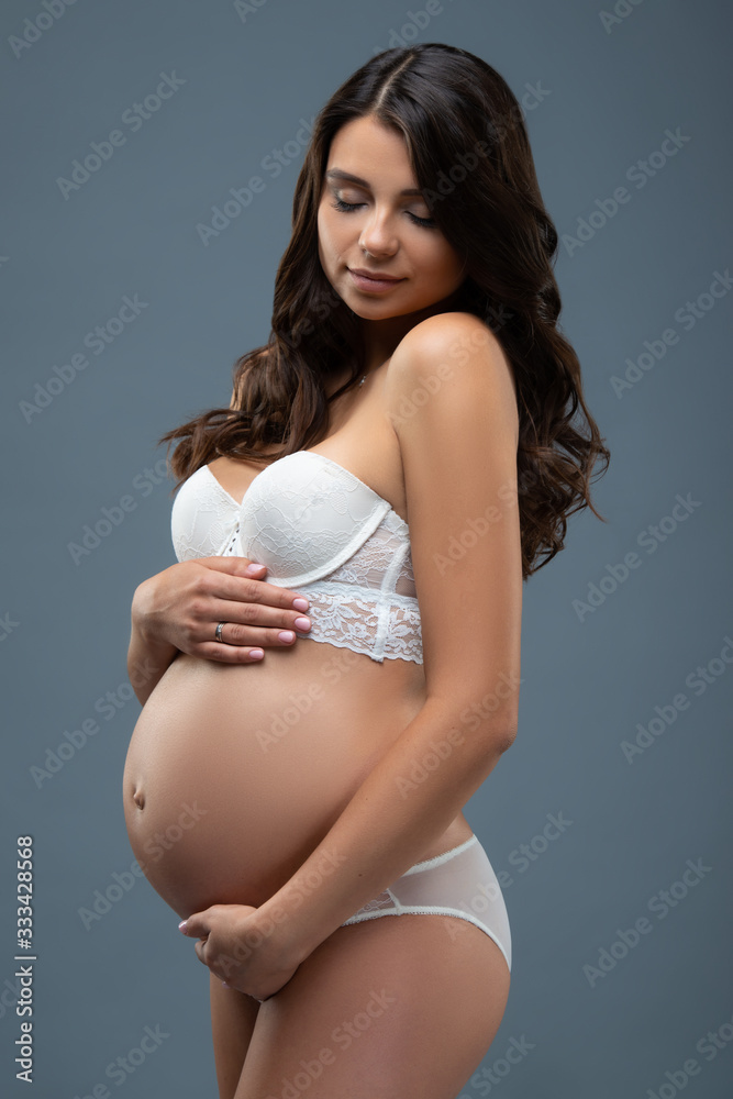 An Beautiful Pregnant Woman In White Bra And Panties And A Green