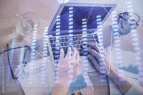 Multi exposure of forex graph with man working on computer on background. Concept of market analysis.