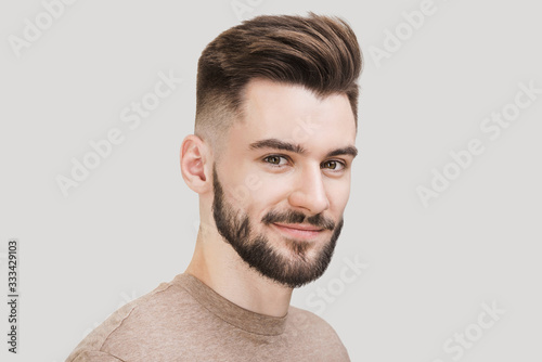 Closeup portrait of handsome smiling young man. Laughing joyful cheerful men studio shot. Isolated on gray background	
