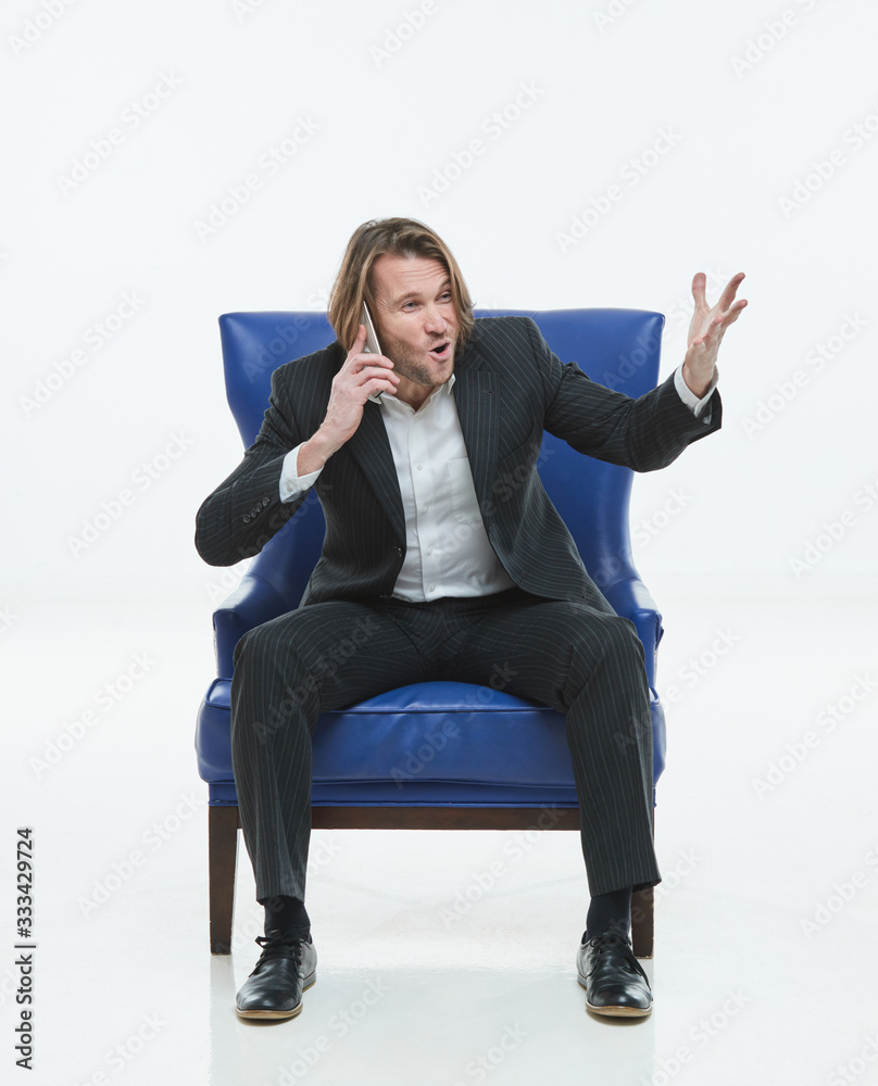 The handsome young man in black suit is at chair, he exults, white background, brutal man with long hairs, white shirts, business man, very stylish, he is happy The handsome young man in black suit is at chair, he exults, white background, brutal man with long hairs, white shirts, business man, very stylish, he is happy