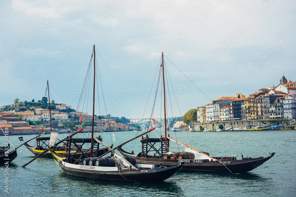 Porto, Região Norte/Portugal - September 16 2019 : View on Porto river with few Boats and beautiful colorful buildings behind 