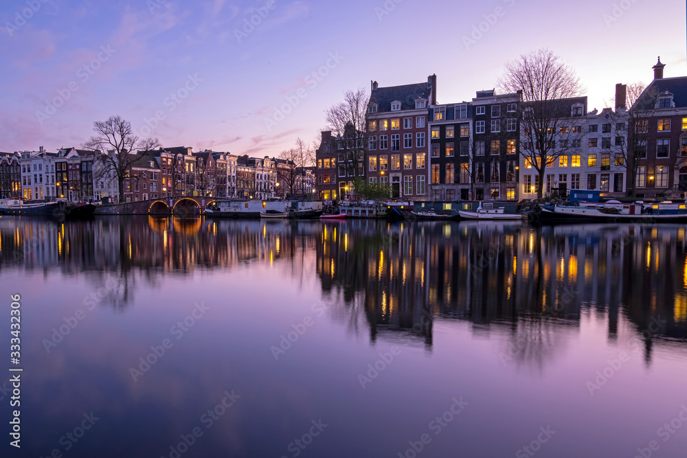 City scenic from Amsterdam  at the Amstel in the Netherlands at sunset