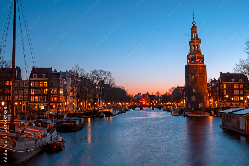 City scenic from Amsterdam with the Montelbaan Tower in the Netherlands at sunset