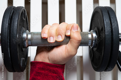 Hand lifting a heavy dumbbell.