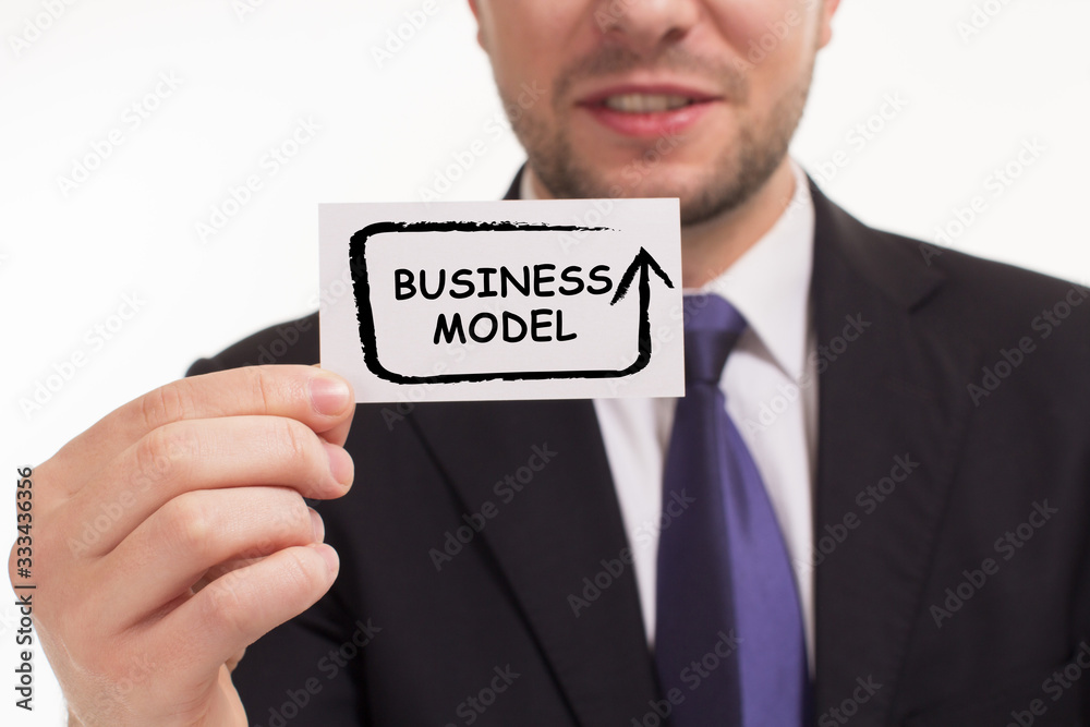 Business, Technology, Internet and network concept. Young businessman working on a virtual screen of the future and sees the inscription: Business model Business, Technology, Internet and network concept. Young businessman working on a virtual screen of the future and sees the inscription: Business model