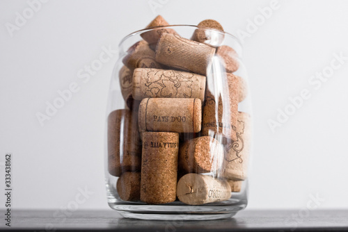 Wine corks lie in a glass jar